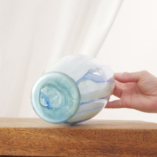 The vase features long, washed-in strokes of transparent blue and green that flow down the glass. Its tall silhouette makes it ideal for statement stems.