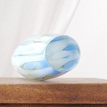 This vase is decorated with fluid, painterly streaks in cool tones that create a calming, organic effect. The glossy finish enhances the layered color.
