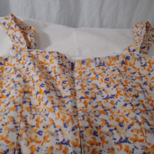 Wide straps and tailored bodice for a flattering fit.  The bodice is crafted from a reclaimed vintage linen fabric in a lively print of orange, blue, and soft ivory.