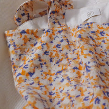 The dress is lined with a breathable linen and rayon blend for comfort, and the skirt is a soft cotton-poly blend, offering both structure and ease of movement.