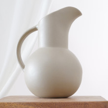 A mid-century Hartstone design, this pitcher is crafted from matte stoneware with a subtle, natural surface. The bold handle and elongated spout showcase its modernist aesthetic.