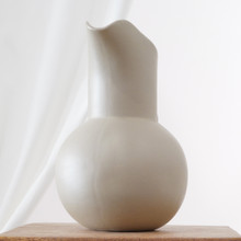 This water pitcher by Hartstone embodies MCM simplicity with its spherical body and tapered neck. The matte finish highlights the clay’s texture while maintaining a soft, understated look.