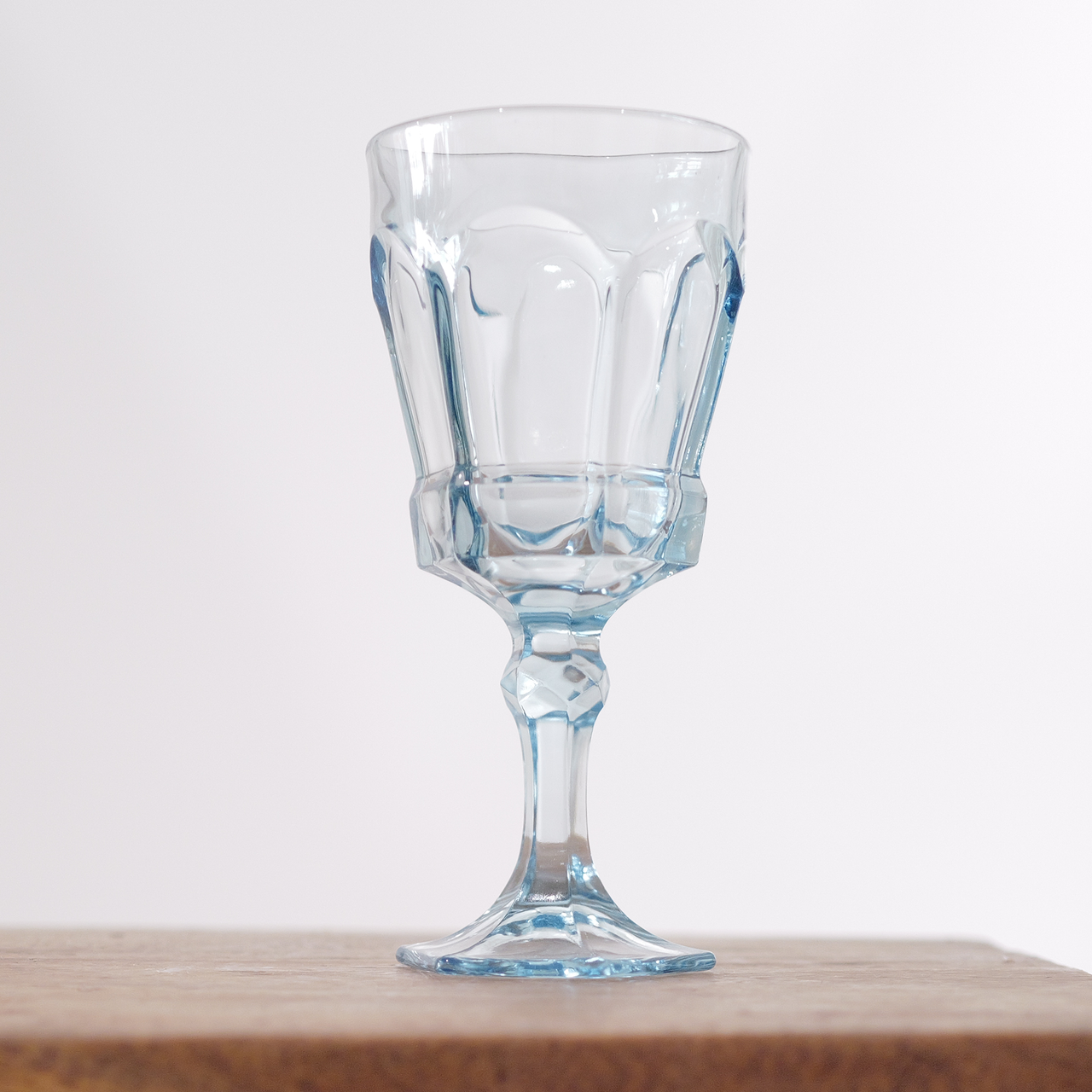 Fostoria Virginia goblet in light blue.  Classic paneled pressed-glass design.  Soft blue tint with beautiful clarity.