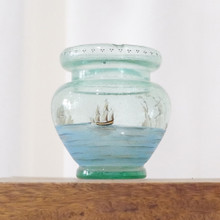 Decorative glass vase with scene of Columbus's voyage to America.