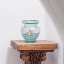 A glass vase with painted scene depicting the fleet of ships from Christopher Columbus's first expedition of 1492, the "Discovery of America."