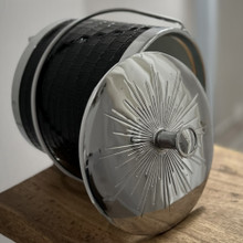 This vintage ice bucket has a black faux alligator / crocodile exterior with chrome details.