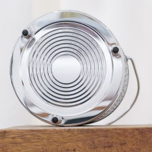 The bottom of this vintage MCM ice bucket is shiny chrome with a design of consecutive circles.