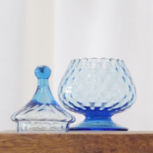 This glass candy jar, made in Empoli, Italy, has a vibrant blue color.