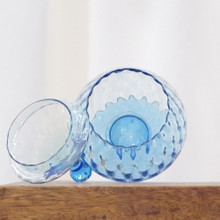 This vintage glass apothecary jar in optic pattern has a removeable lid and foot detail.