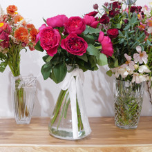 Bouquet of a dozen David Austin roses in a bold magenta.