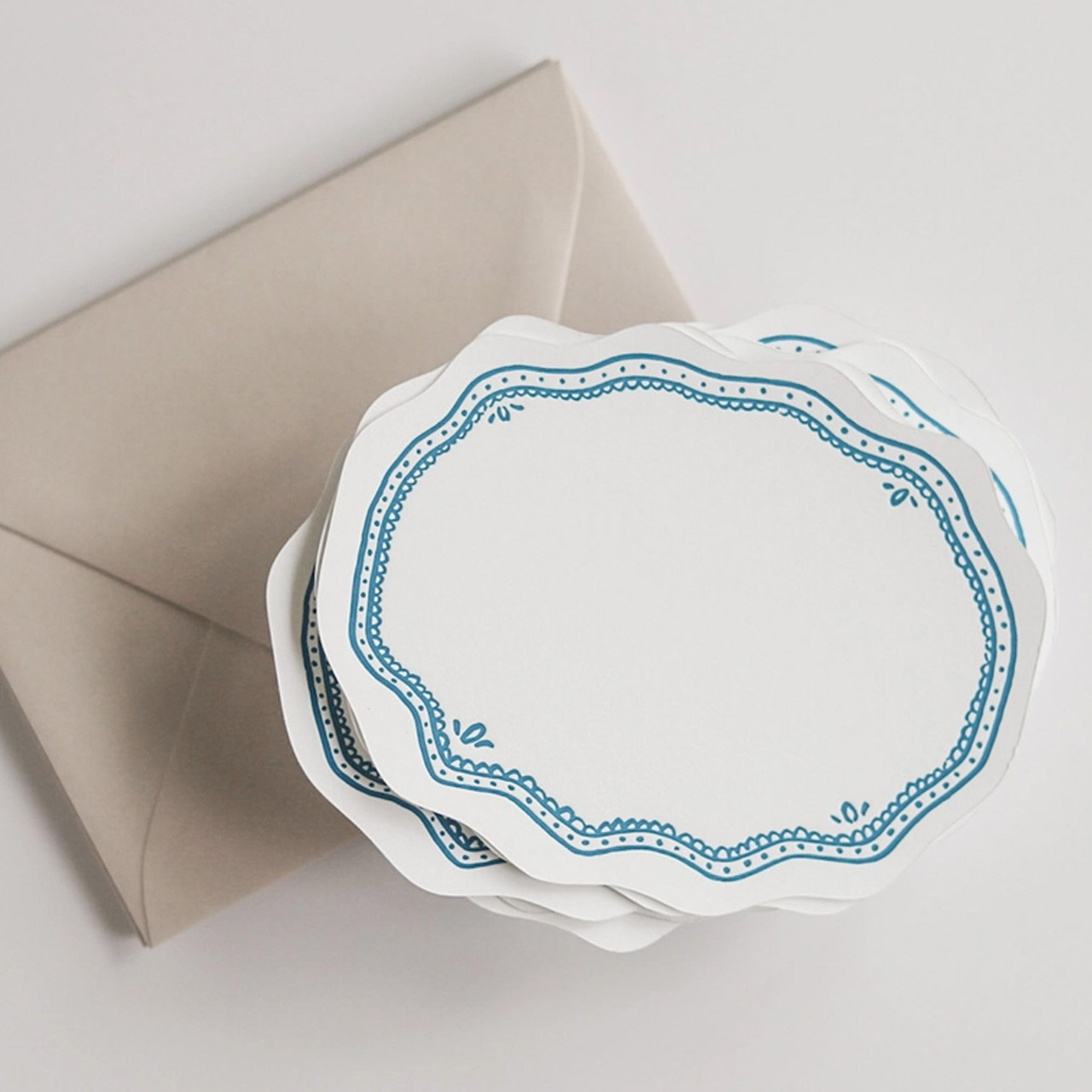 Deliver your message with charm. This note card has a ruffled edge and teal blue letter-pressed border.  Single card.
