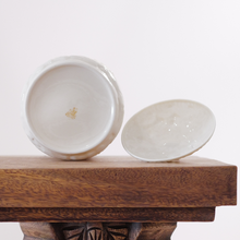 The glaze on this lidded jar is an even ivory tone with a faint pearlescent sheen.