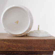 The bottom of this Belleek New Shell lidded jar has the yellow-brown 7th backstamp, indicating a production date between 1980 and 1993.