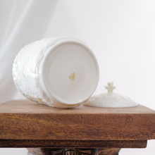 Lightweight yet durable, the Parian porcelain used to make this Belleek lidded jar is translucent when held to the light.