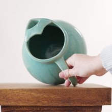 Glossy ceramic jug with clean lines, full body, and balanced proportions.