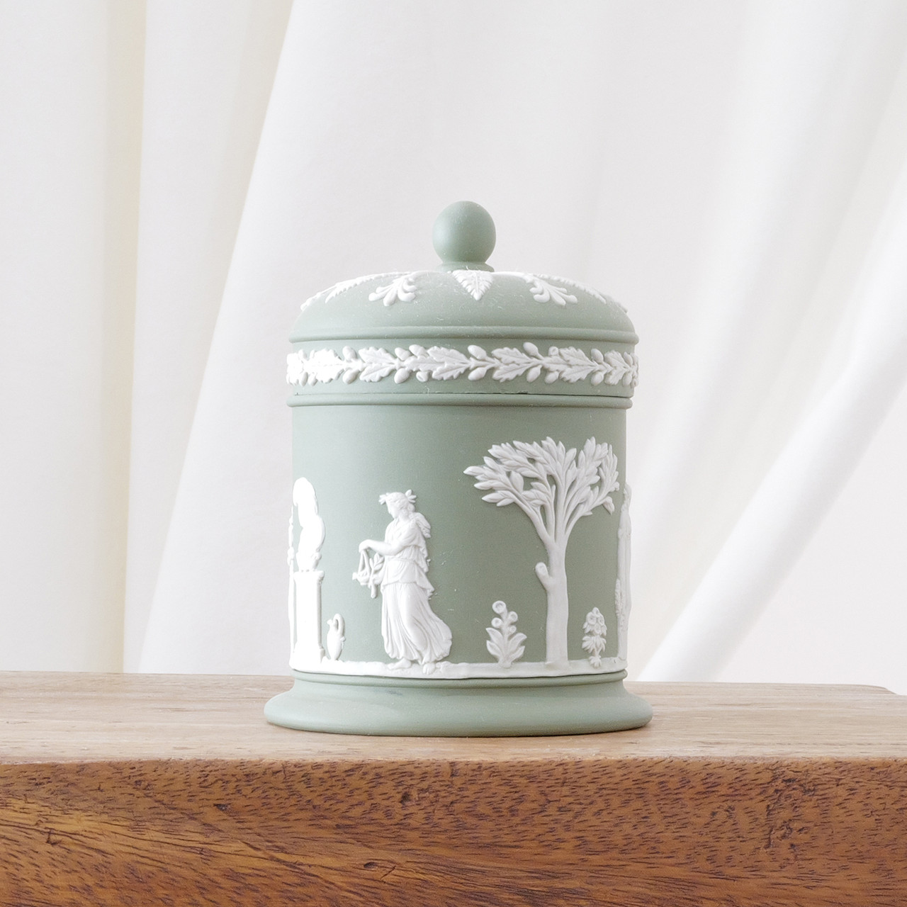 Vintage Jasperware cream on celadon sage green lidded jar with classical white relief made by Wedgwood in England.