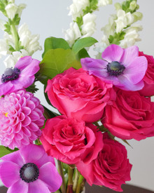 Flower arrangement with purple anemone and hot pink roses.
