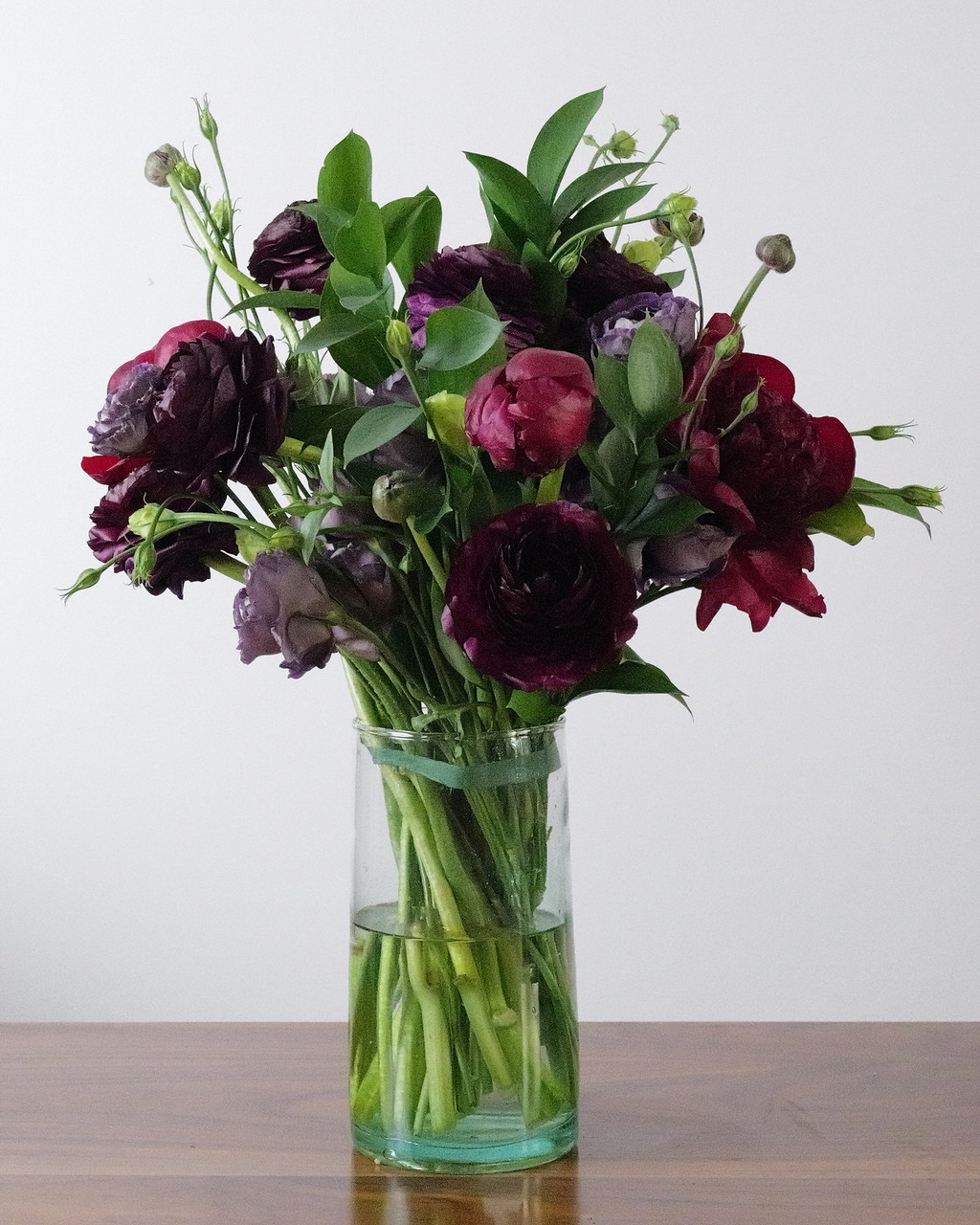 Dark Heart is a dramatic hand-tied bouquet packed with premium burgundy, plum and deep purple flowers for a lush, moody and gothic floral statement.