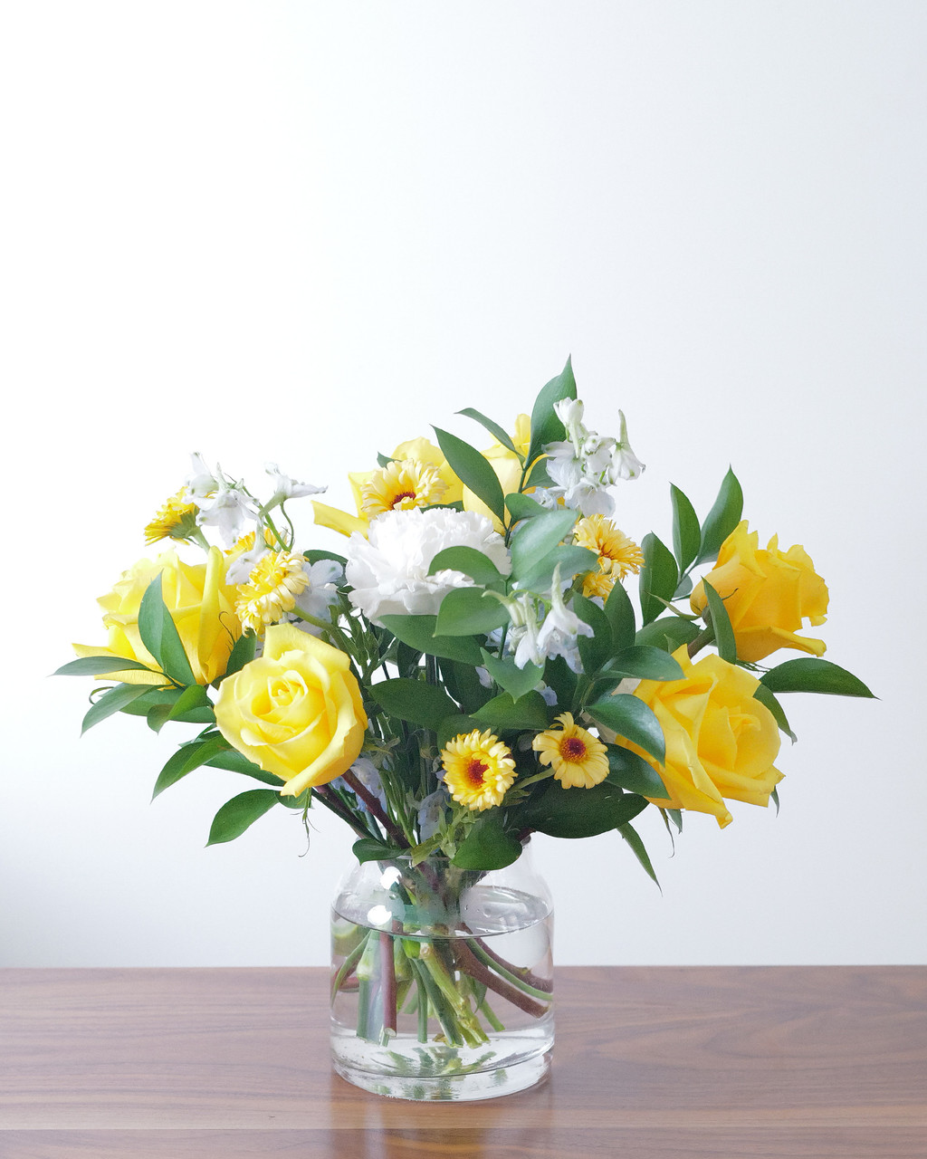 Celebrate a new baby boy with a cheerful arrangement of sunny yellow, soft blue and white flowers designed with the freshest available flowers.