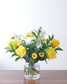 New baby boy flower arrangement featuring sunny yellow, soft blue, and white blooms.