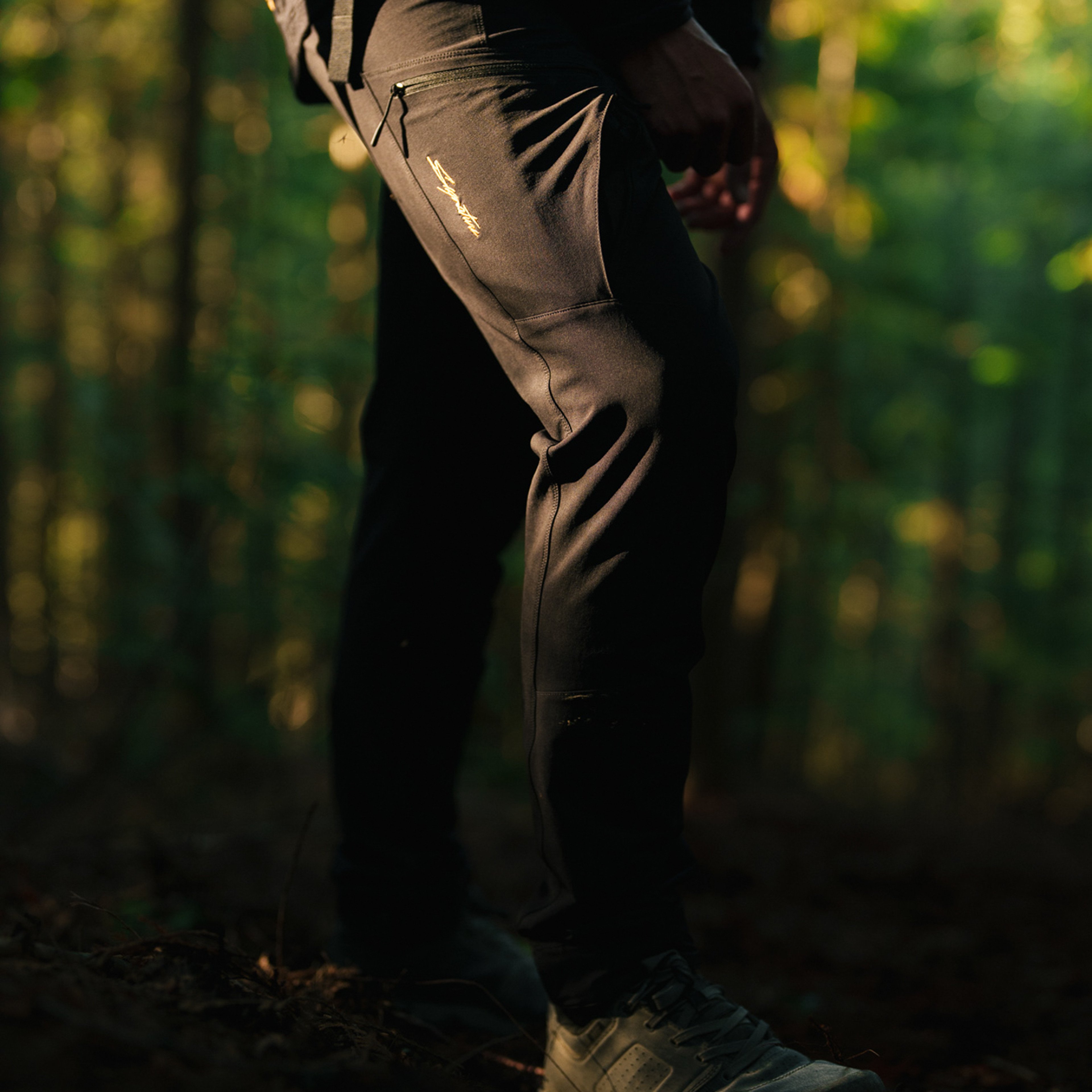 model wearing black pants on the trail
