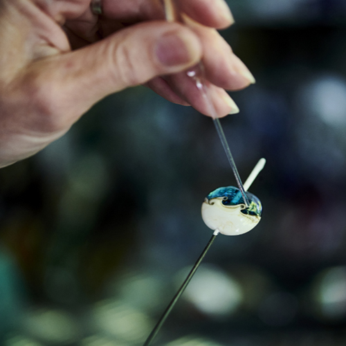 Gail intricately adding detail to a sea bead.