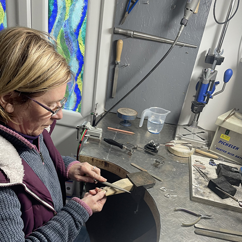 Gail preparing the silver to insert the glass bead