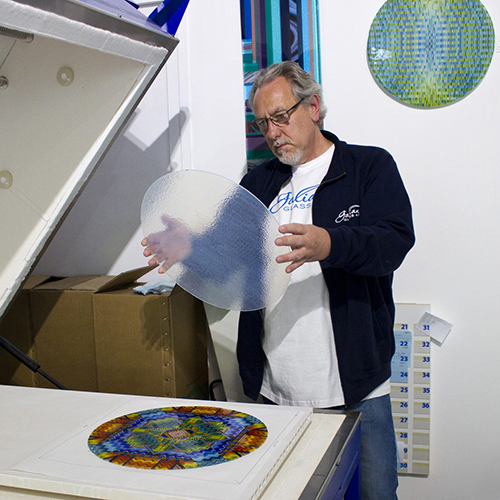 Ian loading an intricate pattern artwork into 'Charlie' kiln.