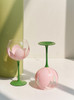 wine glass with pink flower and green stem