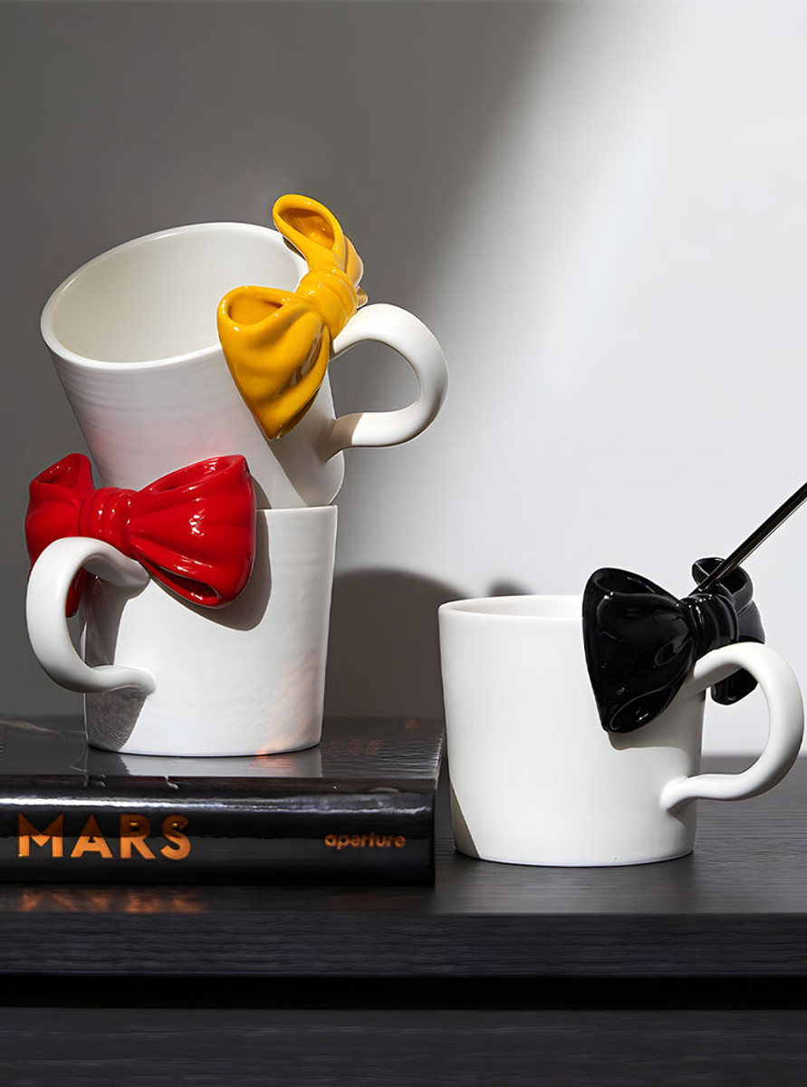 TUTU's "Papillon" mug is a handmade ceramic cup with a unique bow tie design. TUTU's "Papillon" mug is a handmade ceramic cup with a unique bow tie design.