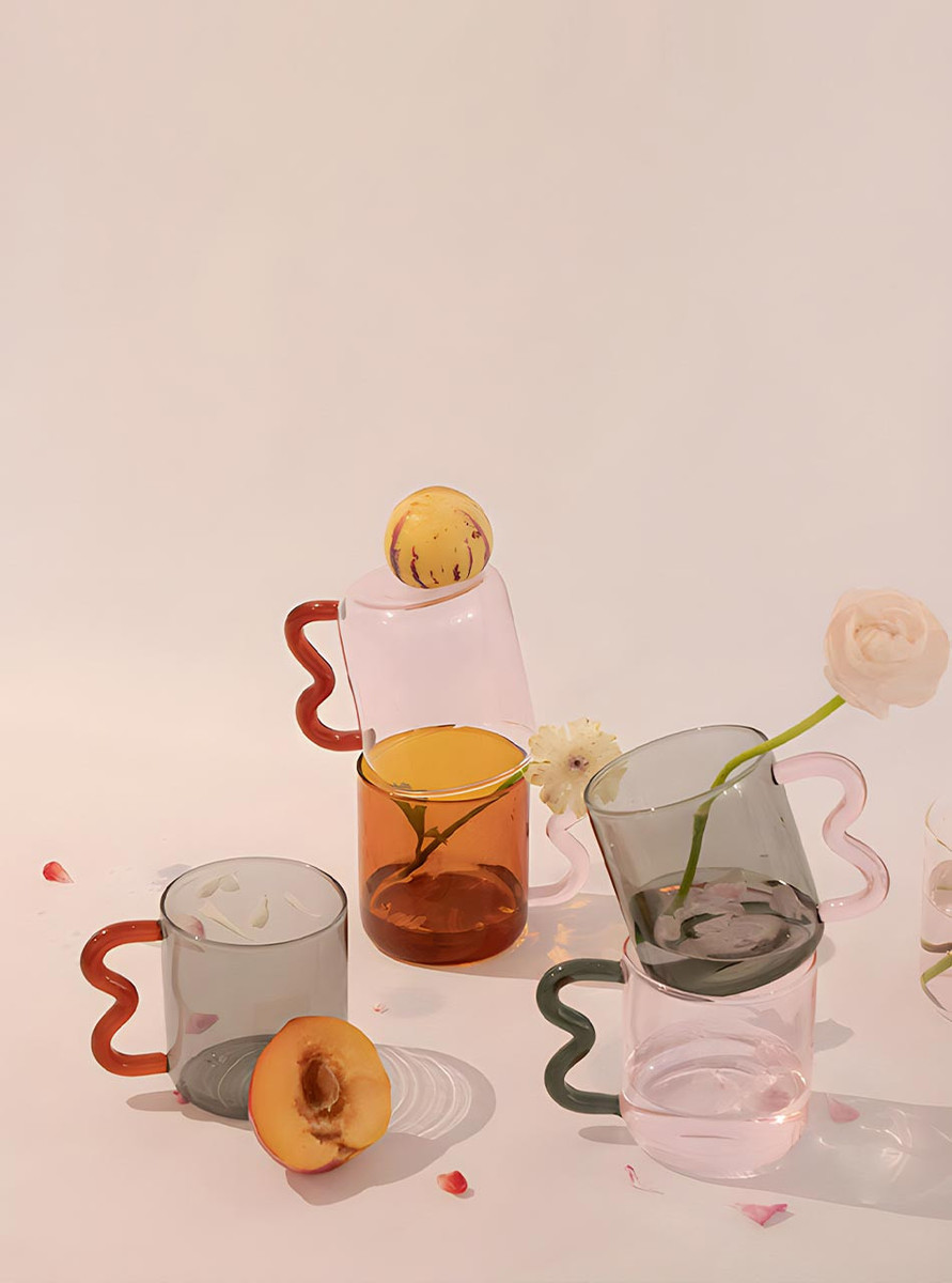 3 different coloured glass mugs ont the table