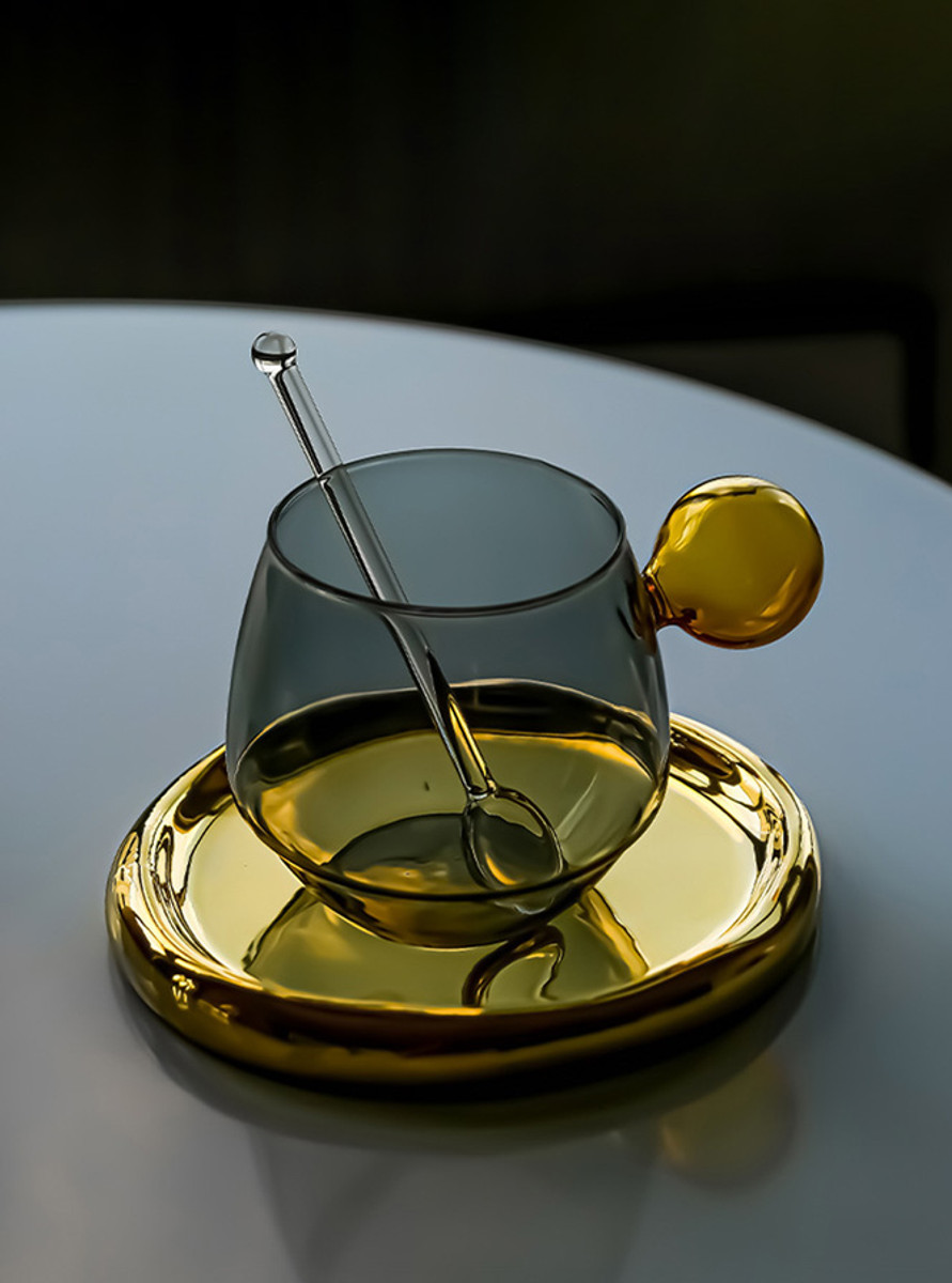 The front view of a  grey glass cup in dim-light