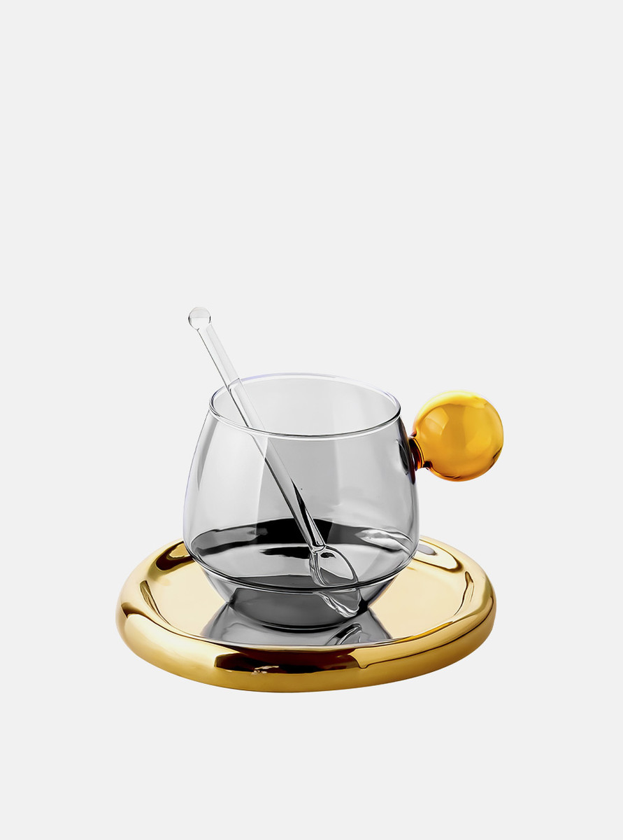 The front view of a  grey glass cup with cute ball handle