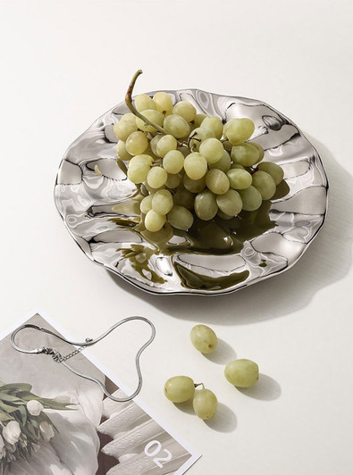 Round silver tray with ocean wave design for fruit display - enhance your food presentation with this stylish and unique tray.