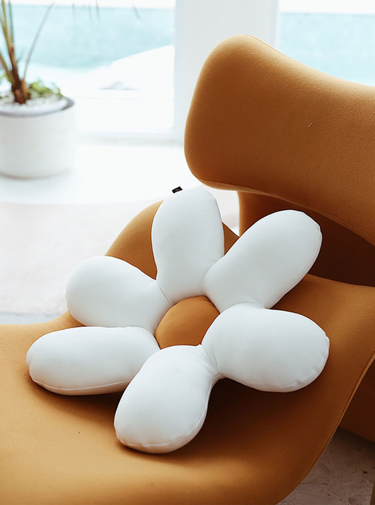 Lily flower shape white cute cushion on a sofa