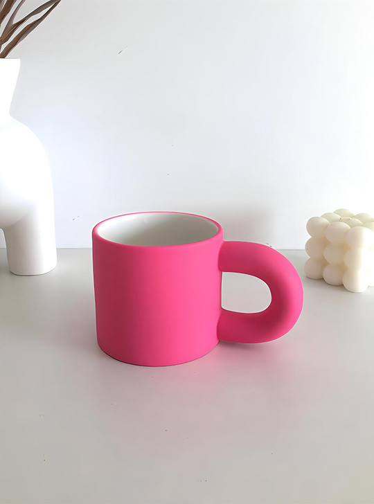 hot pink mug on the desk