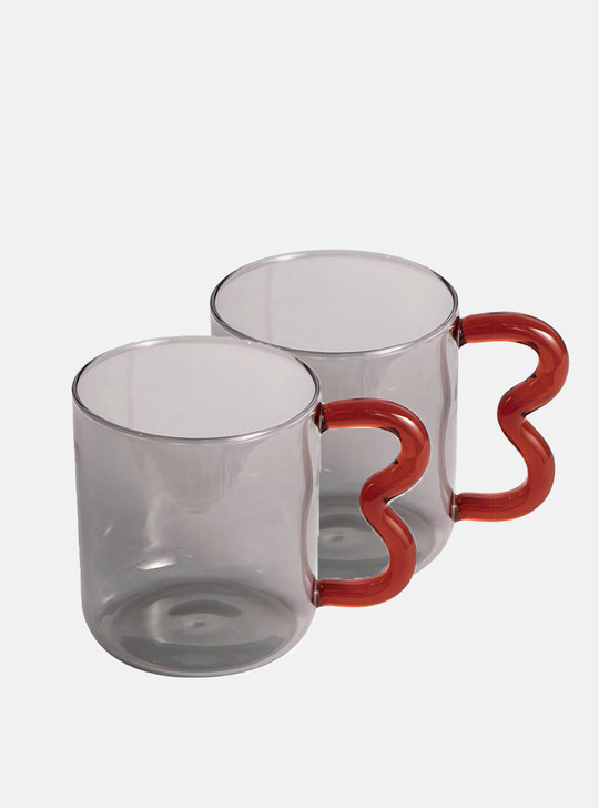 two grey glass cups with wavy handle
