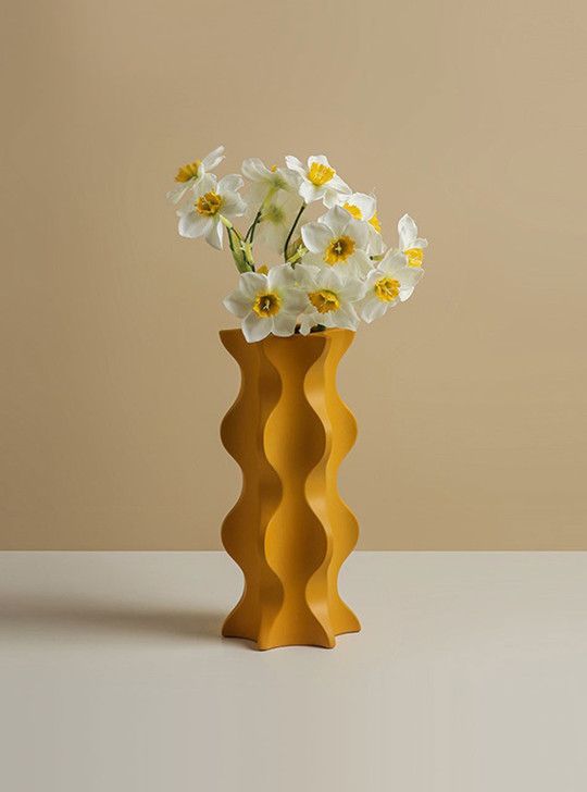 orange funky vase with flowers