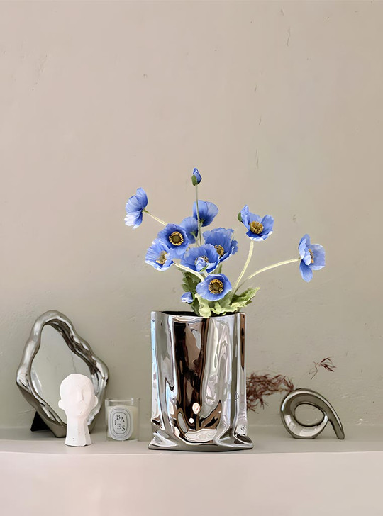 Make a statement with your flower vase! TUTU's "Le Papier" collection features a silver ceramic vase inspired by the form and flow of a paper bag. It's a playful and stylish way to showcase your favourite blooms.