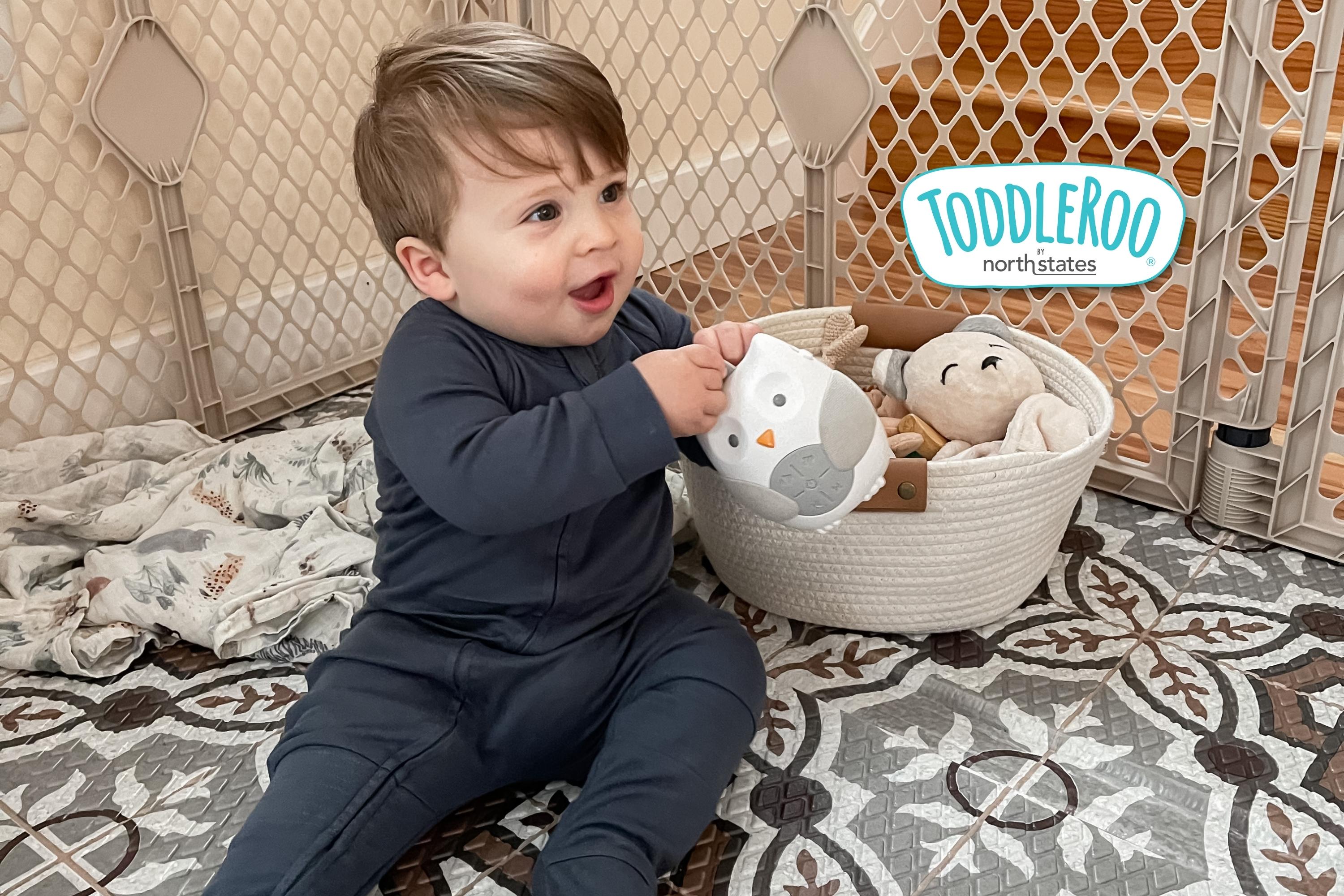 baby playing with toys on a Mosaic Play Mat inside a Superyard Sand