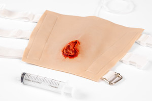 TraumaWear - a wearable & repeat use solution for rapid moulage. This one is simulating a Open Tibial Fracture wound and is simply strapped on to the lower leg. Add Stage Blood to your syringe for simulated bleeding. It is available in 11 different colours.