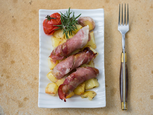 Pancetta wrapped sausages with roasted potatoes and snag jam.