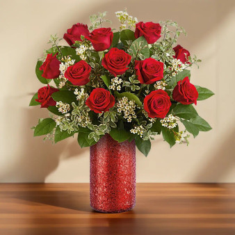 Standard Love Spark Bouquet featuring classic roses arranged with fresh greenery in a red glass vase