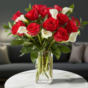 Forever Yours Bouquet featuring red roses and white calla lilies arranged in a clear glass vase, elegant romantic flower arrangement by local florist