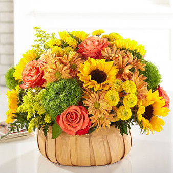 Harvest Sunflower Basket Deluxe featuring sunflowers, orange roses, and dianthus arranged in a rustic woven basket