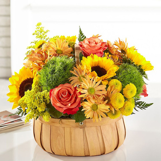 Harvest Sunflower Basket featuring sunflowers, orange roses, and dianthus arranged in a rustic woven basket