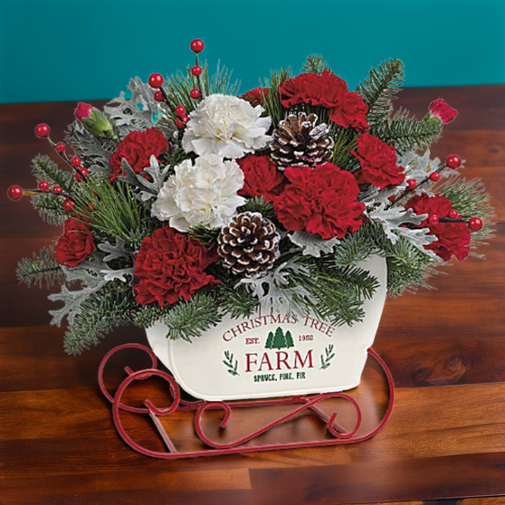 A floral arrangement designed inside a white sleigh