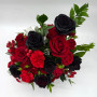 Overhead photo of a beautiful floral arrangement with a mix of black roses and red carnations