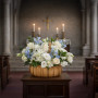 Sincerely Heartfelt Basket Premium with blue and white roses, delphinium, and carnations arranged in a decorative sympathy basket