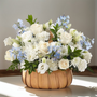 Sincerely Heartfelt Basket Premium with blue and white roses, delphinium, and carnations arranged in a decorative sympathy basket